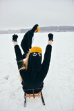 Young couple in the penguin costumes are have fun on snow. Happy Loving Couple