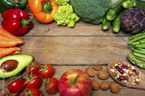 vegan word on wood background and vegetable - food