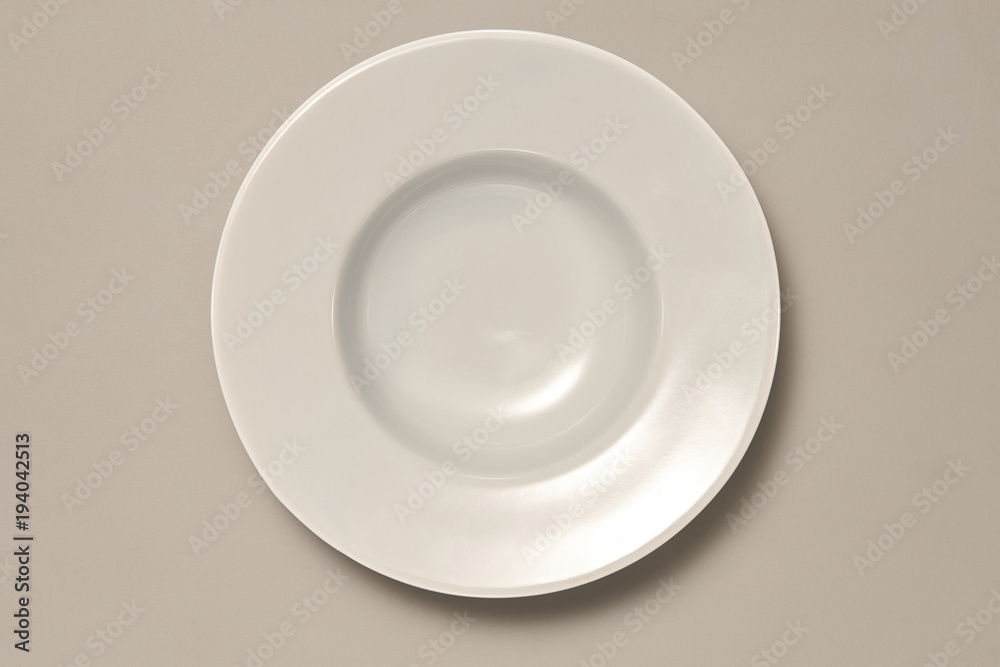 Empty White Bowl or plate isolated on Grey Background with Real Shadow. Top View with Copy Space for Text or Image Empty White Bowl or plate isolated on Grey Background with Real Shadow. Top View with Copy Space for Text or Image