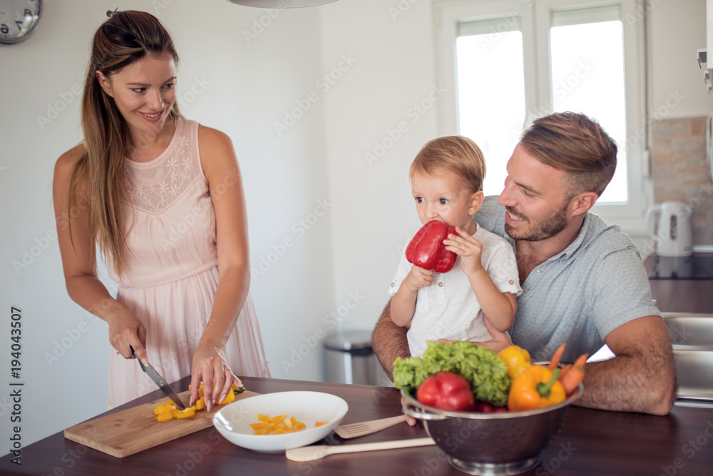 Portrait of a family preparing lunch in the kitchen. Portrait of a family preparing lunch in the kitchen.