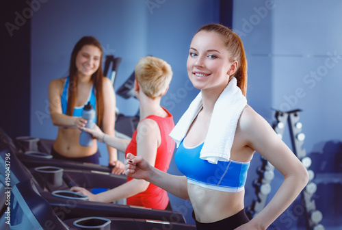 Group of people at the gym exercising on cross trainers. people at the gym photo