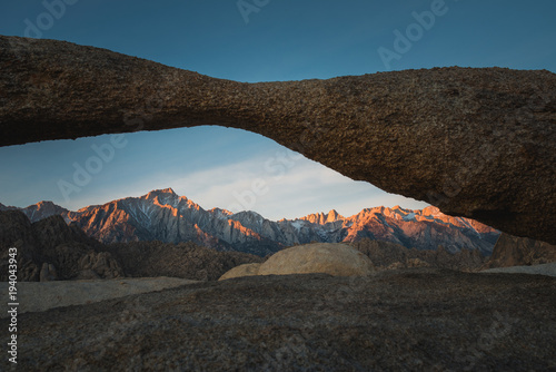 Lathe Arch and the Glowing Lone Pine Peak with the Sierra Nevada Mountains During Sunrise in Alabama Hills, Lone Pine, California