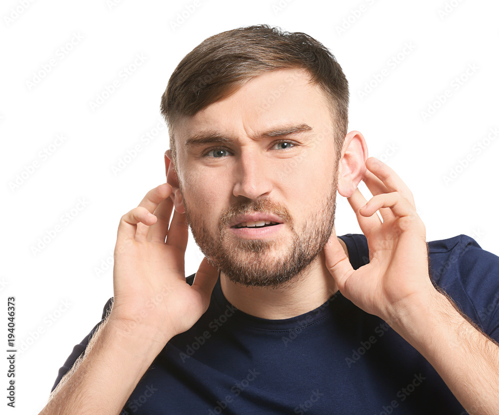 Young man with hearing problem on white background Young man with hearing problem on white background