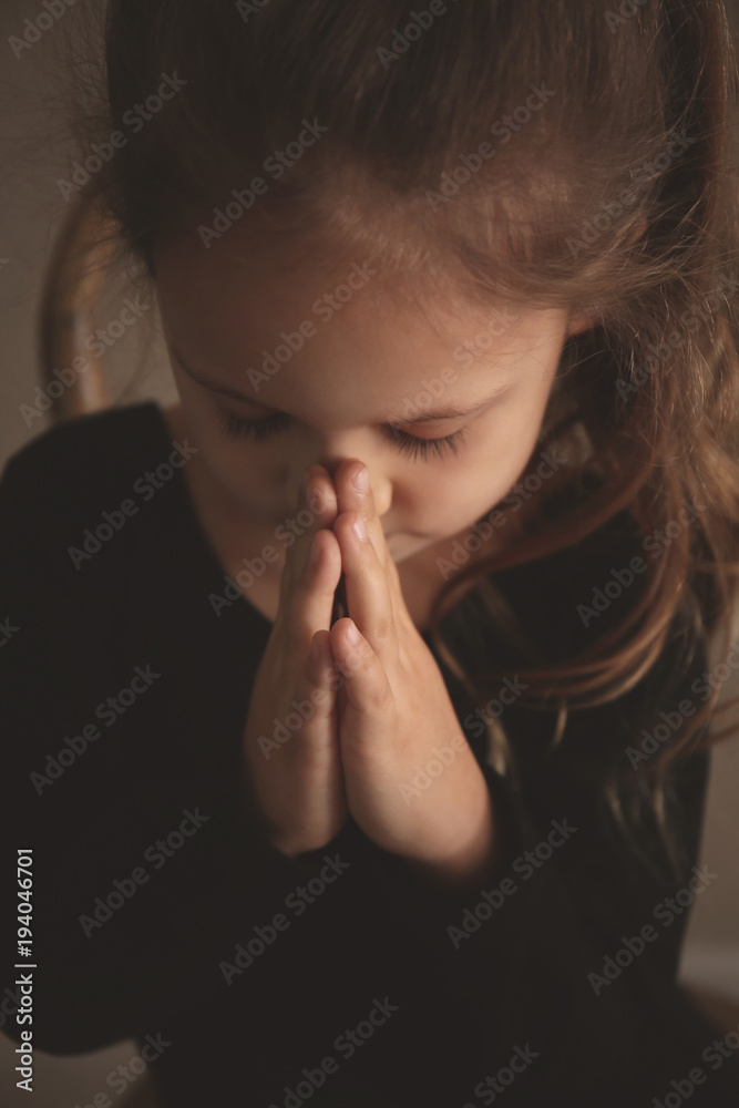 Religious Christian girl praying indoors Religious Christian girl praying indoors