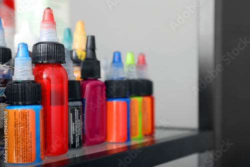 Many bottles with ink in tattoo salon