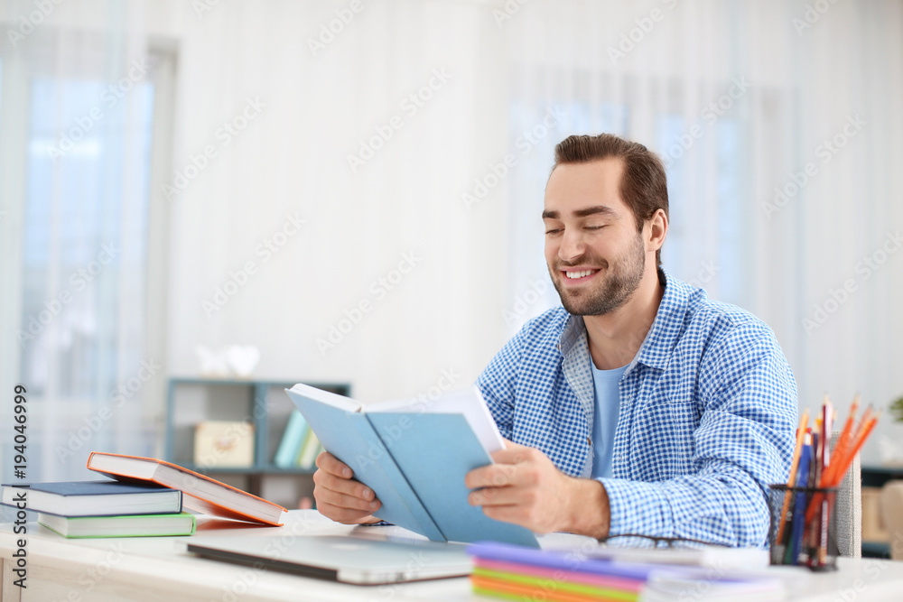 Student studying at table indoors Student studying at table indoors