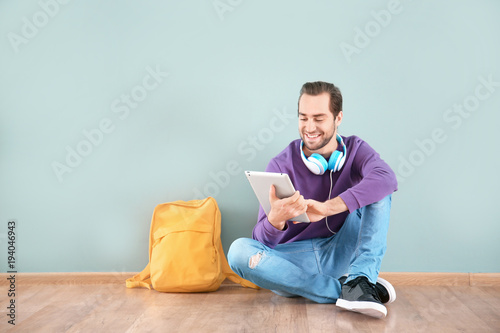 Student with tablet sitting...