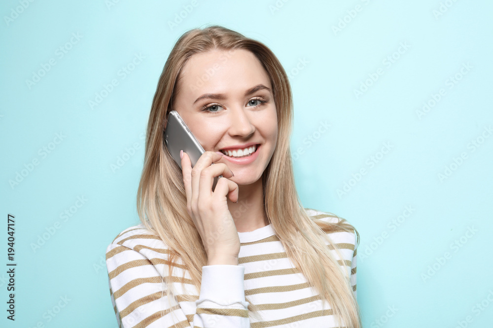 Beautiful young woman talking on mobile phone on color background Beautiful young woman talking on mobile phone on color background