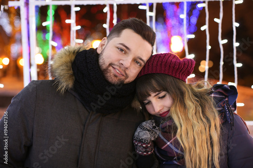 Portrait of young loving couple outdoors on Christmas eve