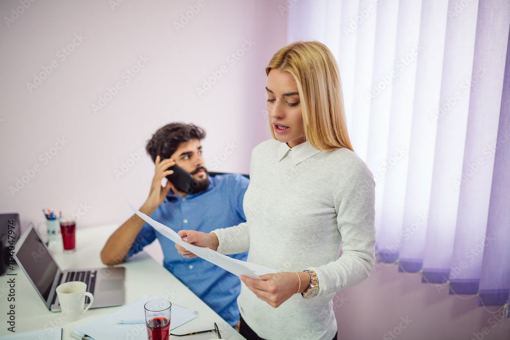 Fototapeta premium Business partners work with documents and smartphone. Manager talking on mobile. Management, leadership concept.