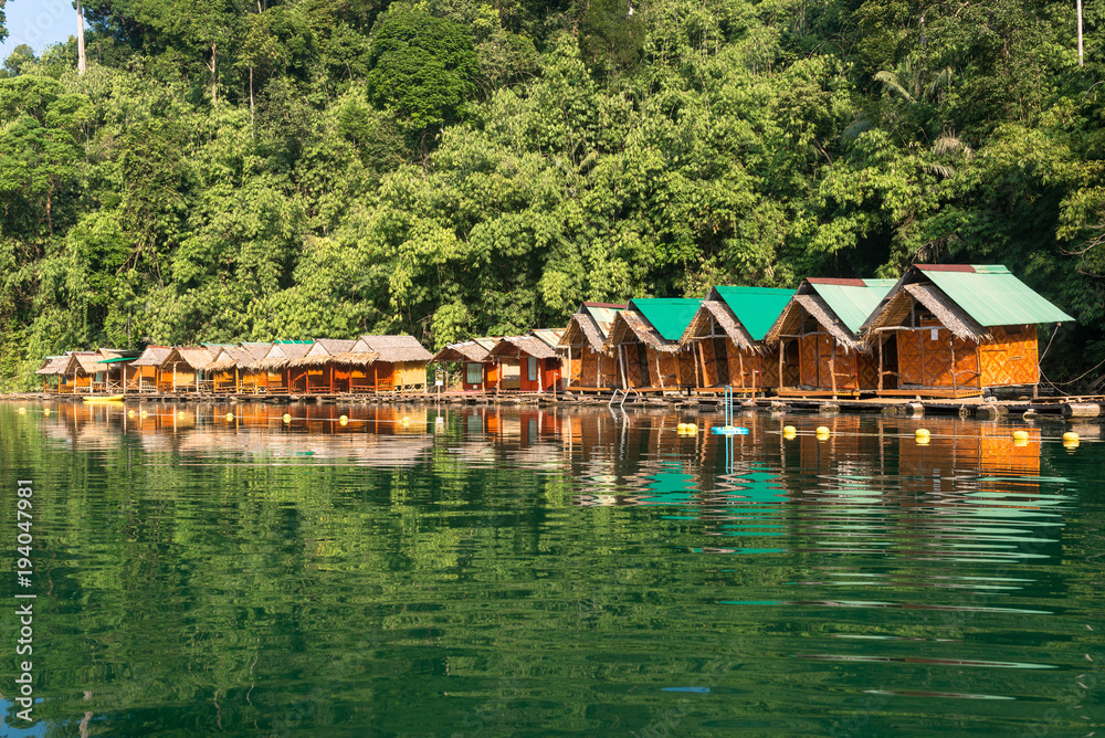 Naklejka premium Raft houses for adventure trip on the Cheow Lan Lake in the national park Khao Sok in Thailand