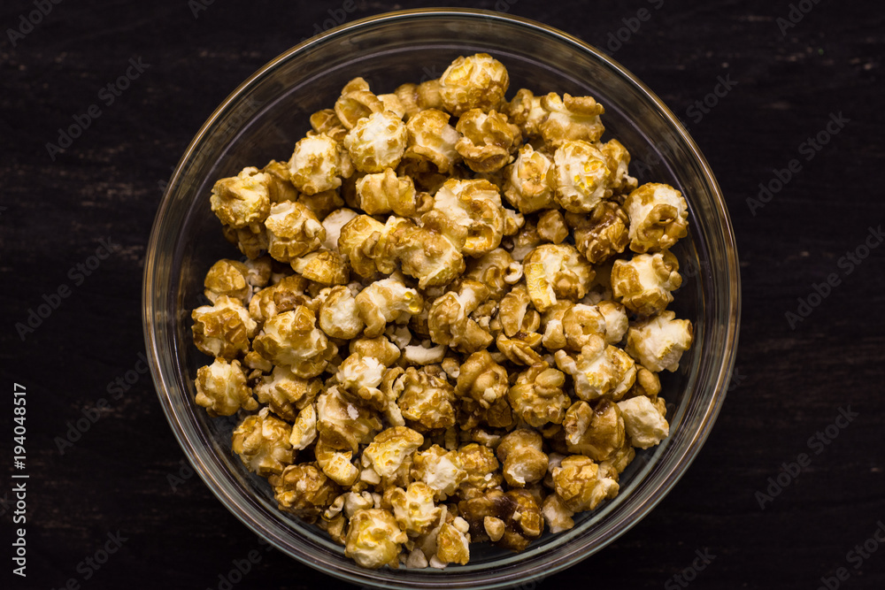 Sweet popcorn on the black background. Popcorn in the bolw. Snack for the movies. Cinema set. Sweet popcorn on the black background. Popcorn in the bolw. Snack for the movies. Cinema set.