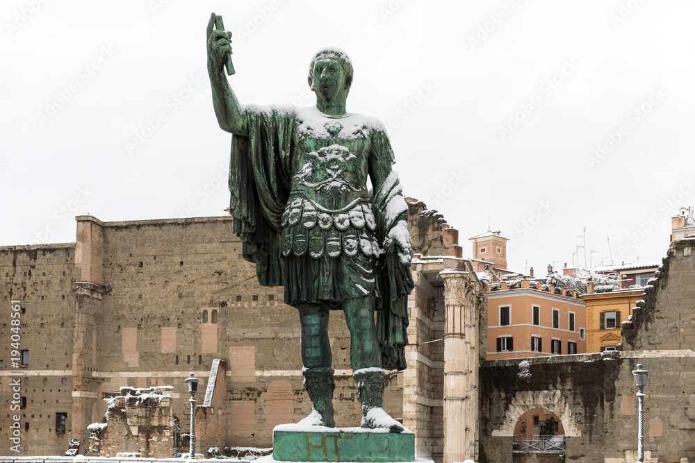 Snow covers the streets of Rome, Italy. Statue of Nerva.