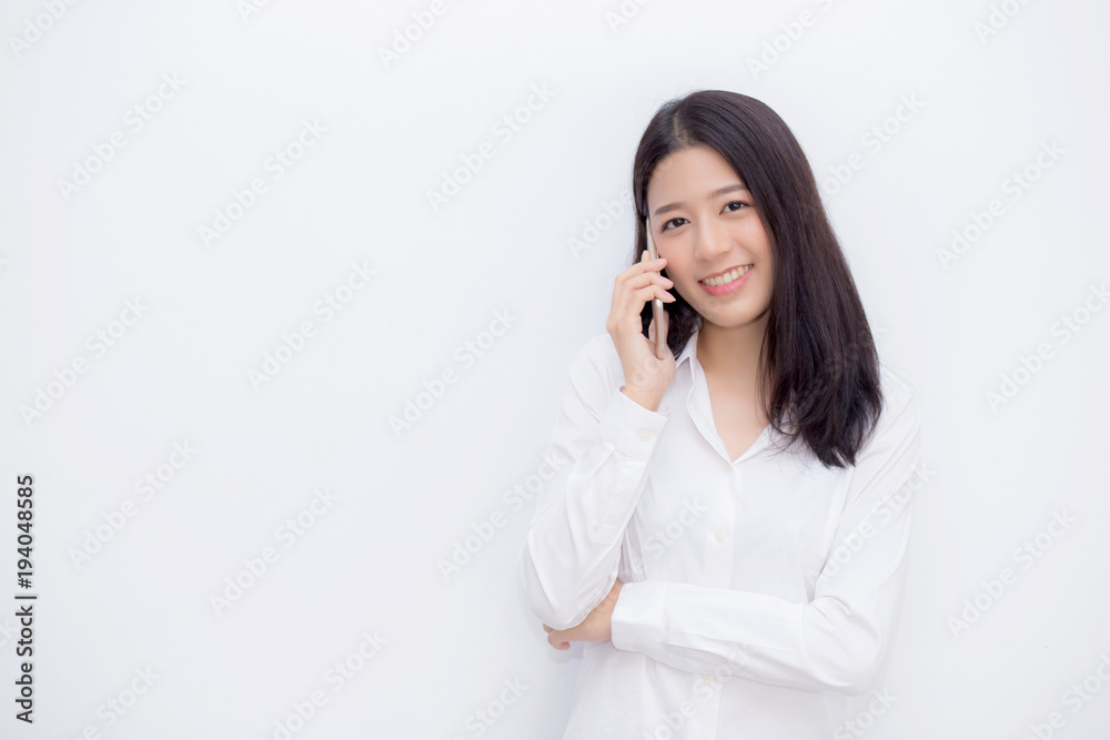 Beautiful young asian woman talking mobile phone and smile standing on cement background, freelancer female calling telephone, communication concept. Beautiful young asian woman talking mobile phone and smile standing on cement background, freelancer female calling telephone, communication concept.