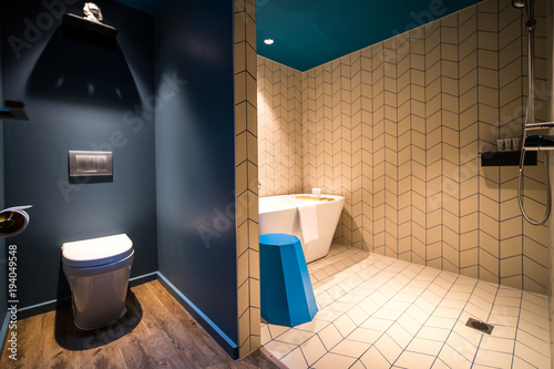 Luxury Modern bathroom with bath tub  white towels and blue stool