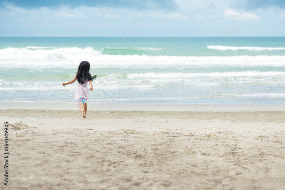 Little children girl with white dress running on a beach Little children girl with white dress running on a beach