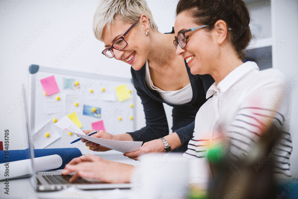 Fototapeta premium Portrait of professional middle aged women working together on projects in the office.