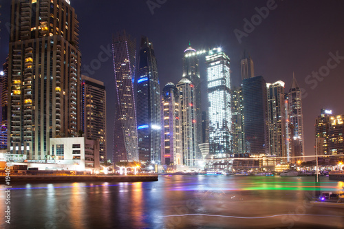 DUBAI  UAE - FEBRUARY 2018  Colorful evening on canal and promenade in Dubai Marina Dubai United Arab Emirates