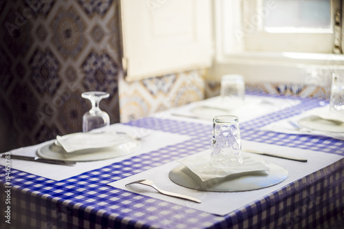 Table in traditional Portuguese restaurant ready for four people © malajscy
