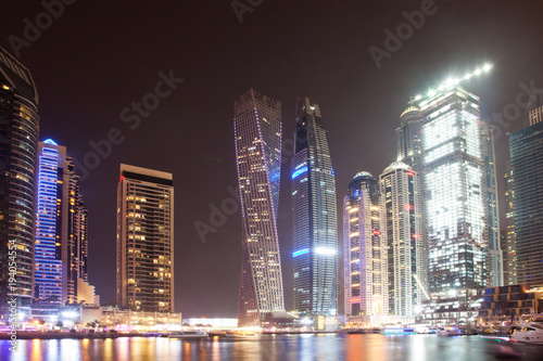 DUBAI, UAE - FEBRUARY 2018: Colorful evening on canal and promenade in Dubai Marina,Dubai,United Arab Emirates