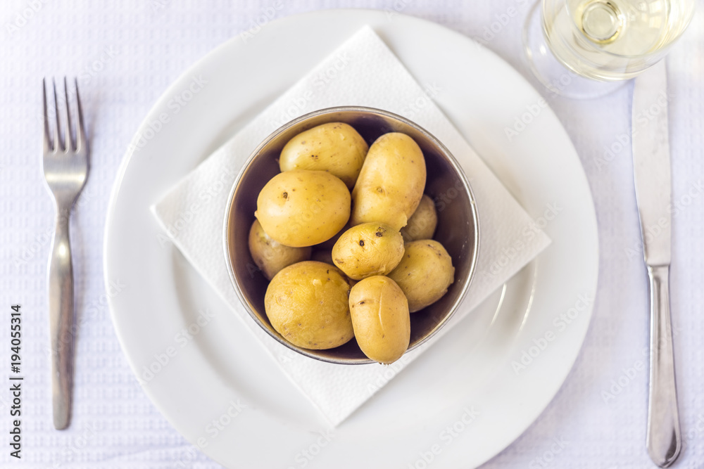 Cooked baby potatoes and white wine