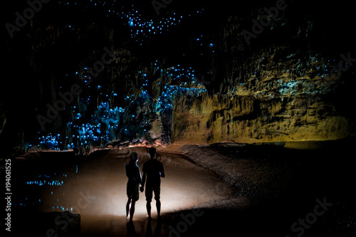 Couple under New Zealand Glow Worm Sky in Waipu Cave