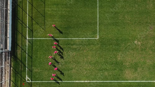 Top down aerial footage of amateur soccer players during warm up