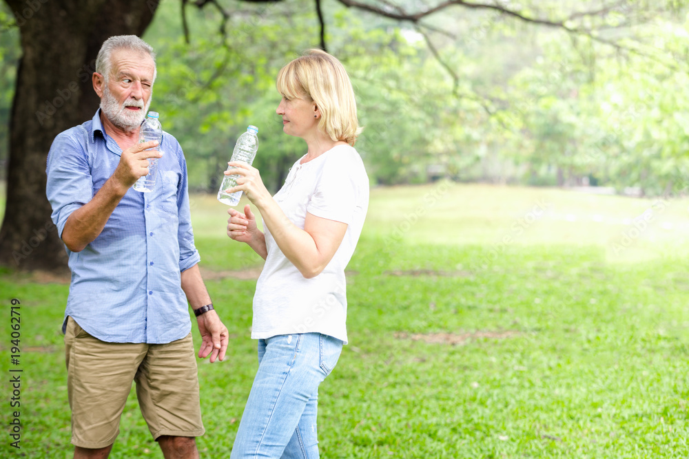 Fototapeta premium Senior couple standing drinking water