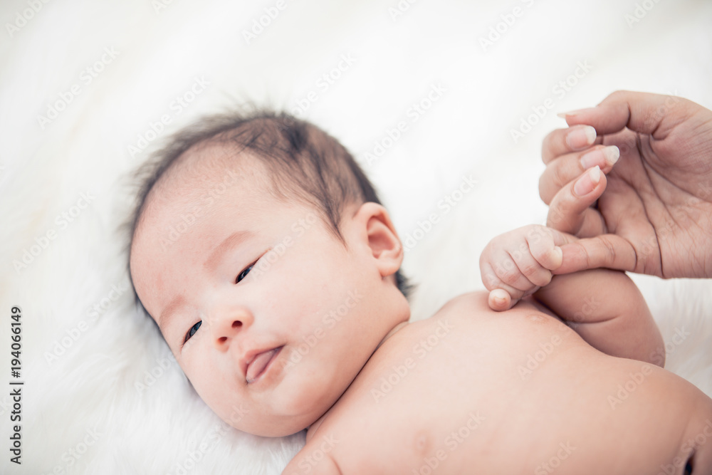 Baby sleeping in bed and hand holding his mom Baby sleeping in bed and hand holding his mom