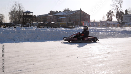 Winter carting on the snow track. Winter karting competition on the ice track. Winter carting. Racing karting in slow motion