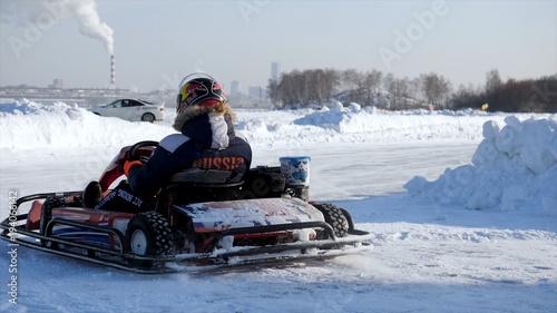 Winter karting competition on the ice track. Winter carting. Racing karting in slow motion