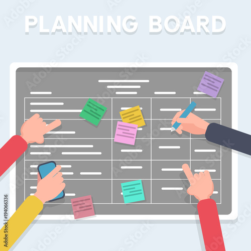Business software development team planning iterations together. Scrum methodology task board full of tasks on sticky note cards. Hands sticking writing on blackboard.