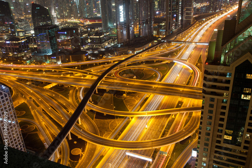 DUBAI, UAE - FEBRUARY 2018: Night traffic on a busy intersection on Sheikh Zayed highway