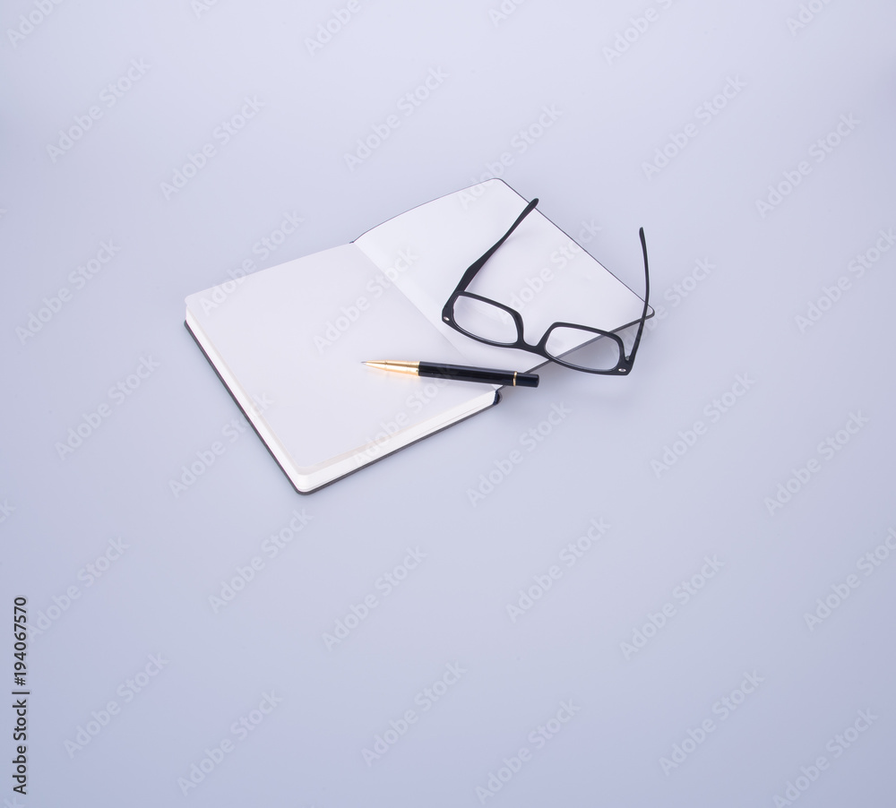 notebook with glasses and pen on the blackground. notebook with glasses and pen on the blackground.