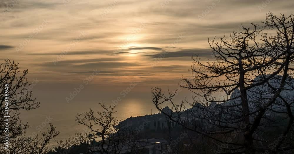 The time-lapse sun sets over the horizon and the city falls asleep The time-lapse sun sets over the horizon and the city falls asleep