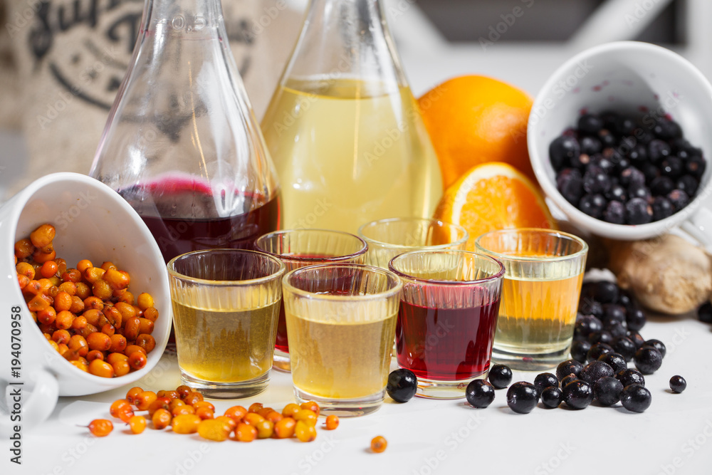 Currant wine in a bottle on wooden table. Sweet alcohol made from many varieties berry fruits Currant wine in a bottle on wooden table. Sweet alcohol made from many varieties berry fruits