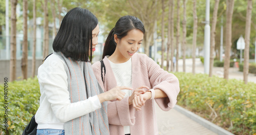 Fotografie Friends finding shop location on smart watch at outdoor