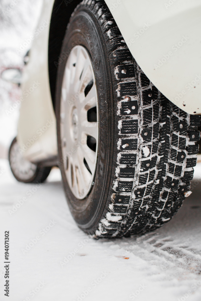 Closeup of car tires in winter. the first snow in late autumn