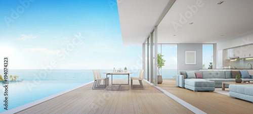 Outdoor dining and sea view living room beside kitchen of luxury beach house with terrace near swimming pool in modern design. Vacation home or holiday villa for big family. Interior 3d illustration. © terng99