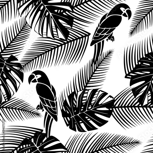 Black and white seamless tropical pattern with leaves and parrots.
