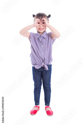 Full length of little asian girl standing and smiles over white background © gamelover