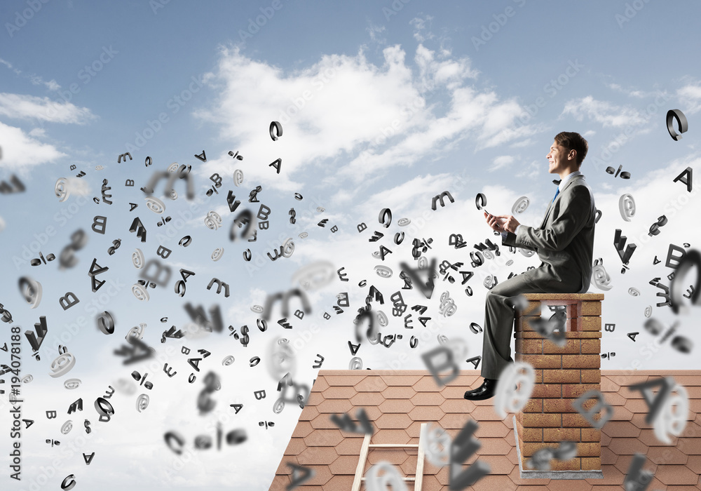 Man on brick roof working with smartphone and symbols flying around Man on brick roof working with smartphone and symbols flying around