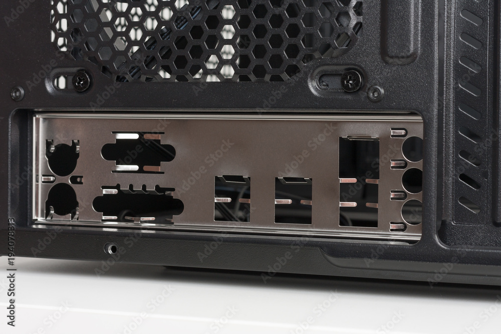 Fototapeta premium Back side of empty midi tower computer case on white table.