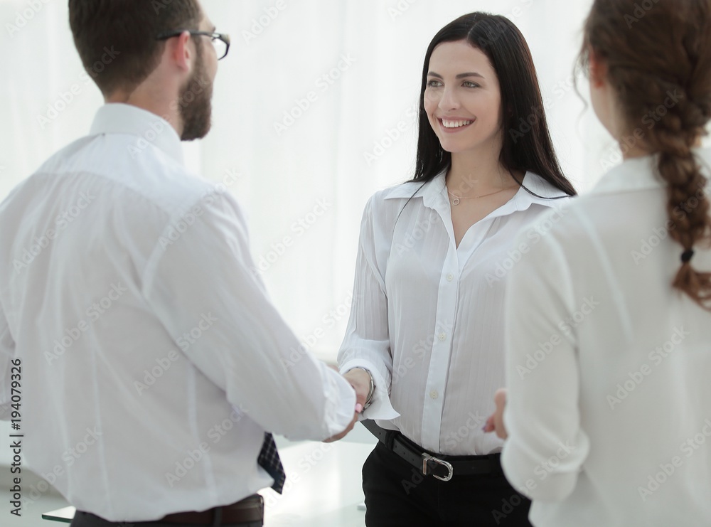 handshake of a female executive and employee of the company. handshake of a female executive and employee of the company.