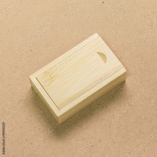 Small wooden box on brown texture background. Template of wood packaging made from bamboo material.