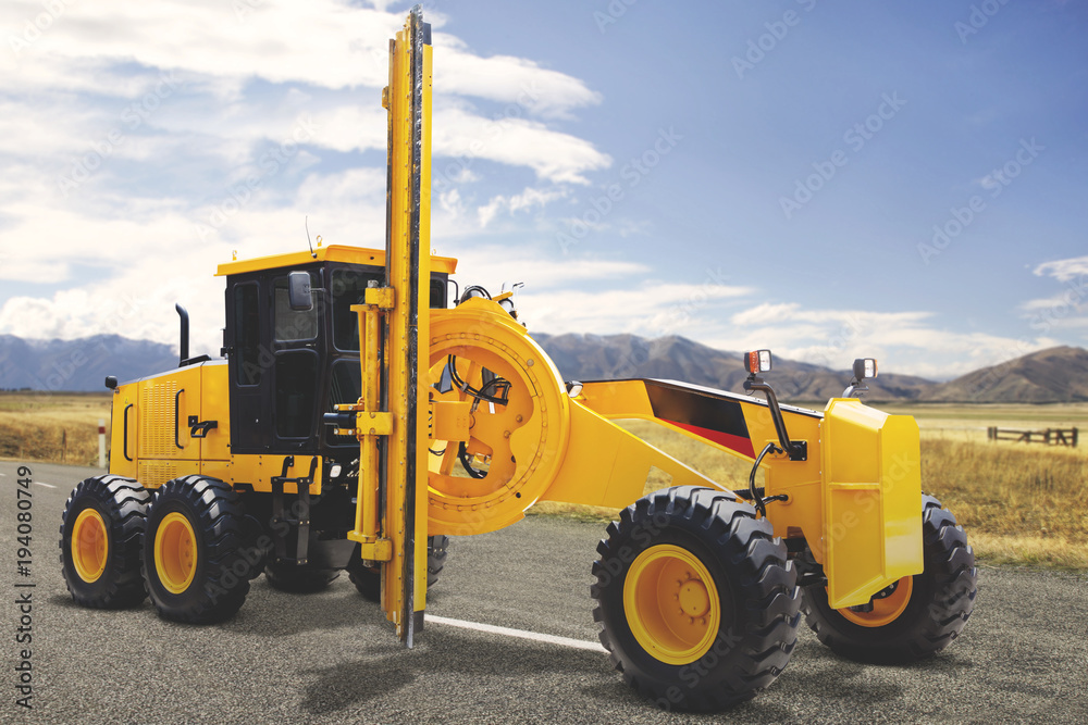 Yellow grader parking on the asphalt road construction site