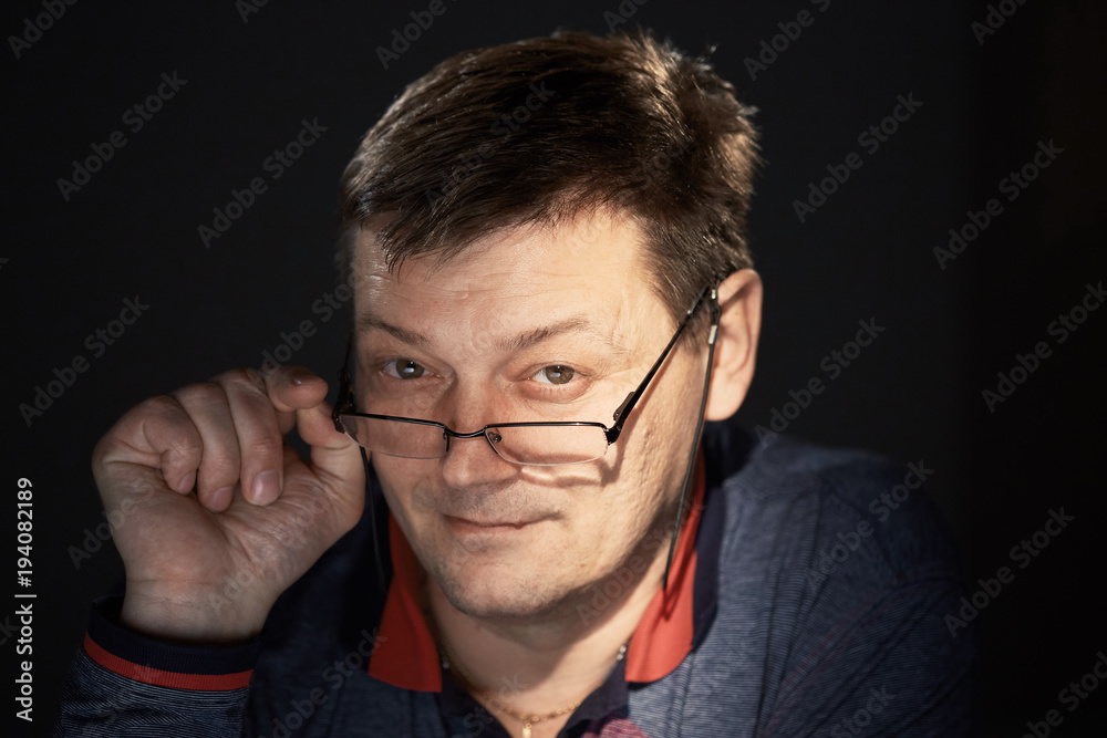portrait of a man in the studio on a dark background. portrait of a man in the studio on a dark background.