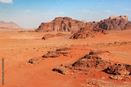 Red mountains of the canyon of Wadi Rum desert in Jordan. Wadi Rum also known as The Valley of the Moon is a valley cut into the sandstone and granite rock in southern Jordan to the east of Aqaba. photo