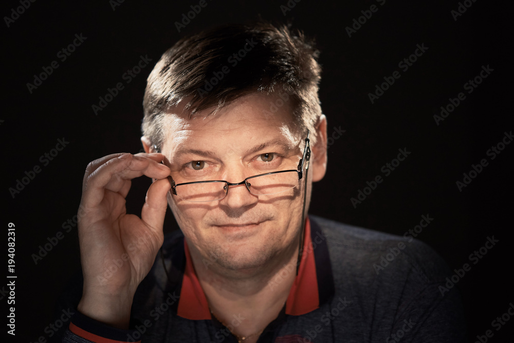portrait of a man in the studio on a dark background. portrait of a man in the studio on a dark background.