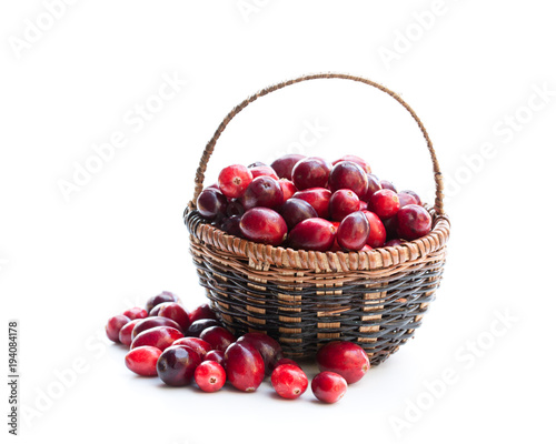 Fresh  cranberries in small wicker basket isolated on white